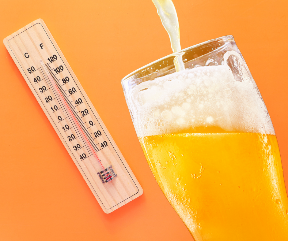 A refreshing glass of beer next to a thermometer displaying the current temperature, suggesting a hot day.